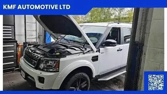 Car repair near me at KMF Automotive Ltd showing white SUV with open hood during vehicle inspection